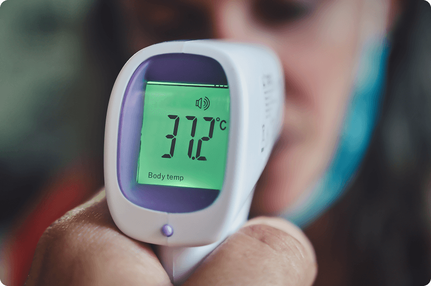 Infrared thermometer reading displays temperature while maintaining normal room temperature conditions home.