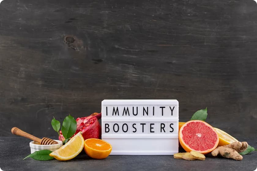 Citrus fruits and ginger around an immunity boosters sign representing acquired immunity definition.