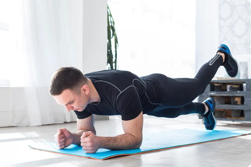 Man performing plank bodyweight exercises for core and arm workouts without equipment