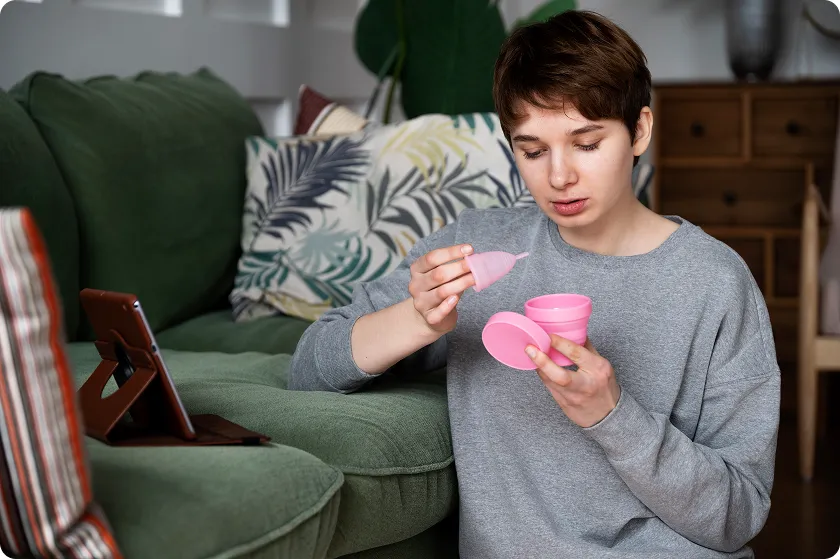 Doctor inserting IUD birth control device to demonstrate long-term pregnancy protection method.