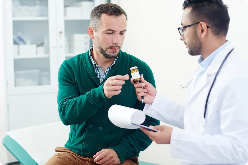 Patient discussing stages of coronary artery disease with doctor, chest pain.