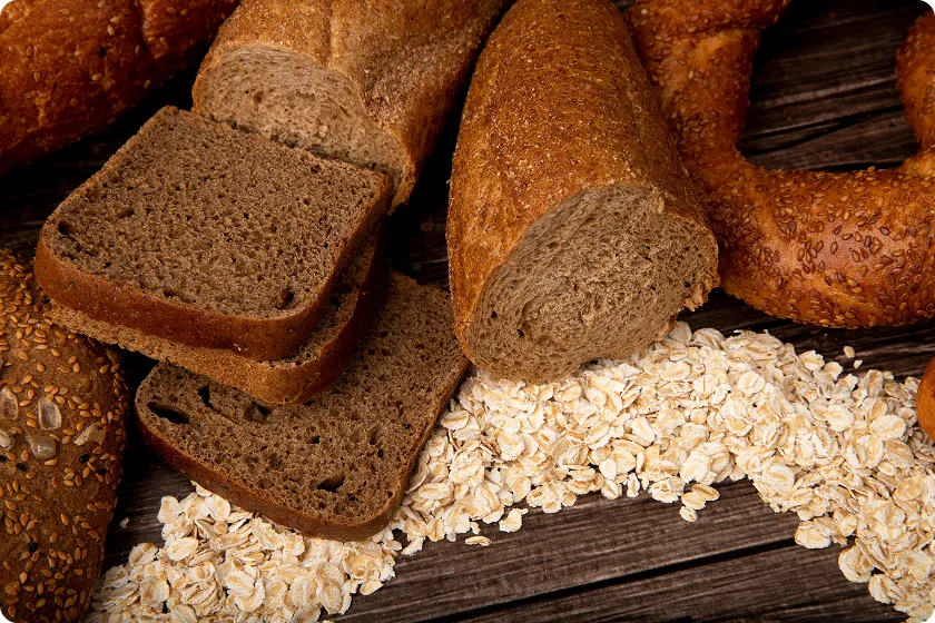 Freshly baked sliced loaves displayed alongside oats for understanding complete bread nutrition facts.