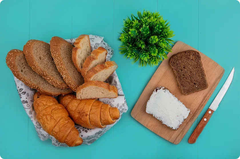 Assorted sliced loaves showing different textures to help analyze bread carbohydrate content.