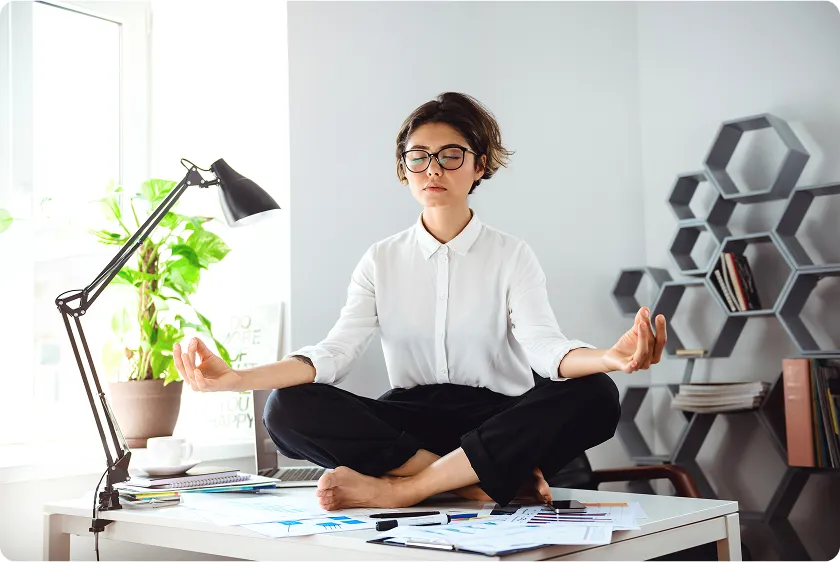 Woman practicing deep breathing to show how to lower blood pressure instantly and relax naturally.