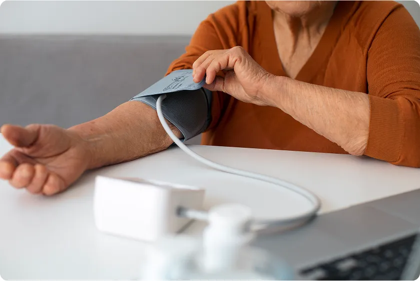 Person seasoning food lightly to show how to lower blood pressure instantly by reducing salt.