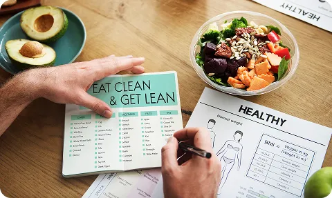 Meal plan notebook with salad foods that are low carb high fat