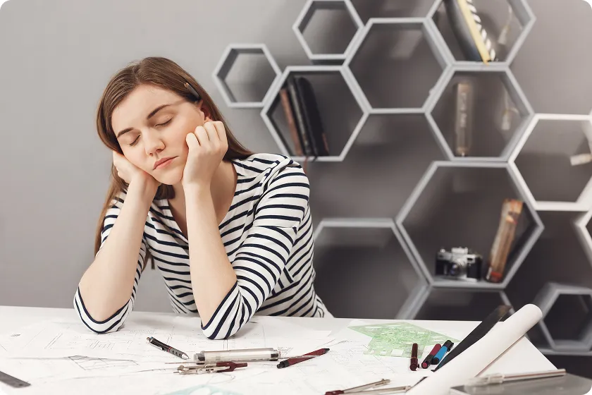 Doctor experiencing Mounjaro fatigue while managing tirzepatide side effects at work.