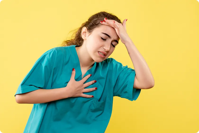 Woman with hand on chest and forehead feeling discomfort