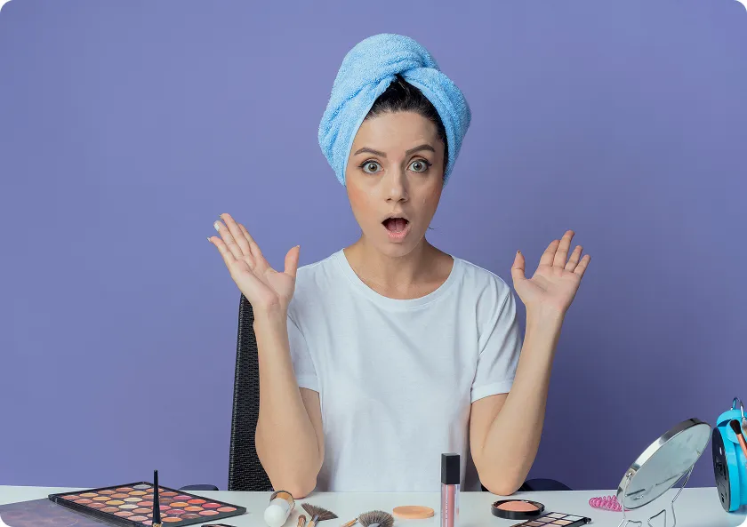 Woman applying moisturizer as part of a daily skin care routine