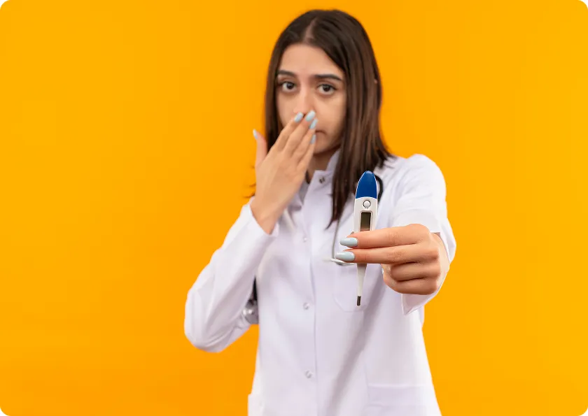 Doctor holding thermometer demonstrating sublingual immunotherapy versus allergy shots