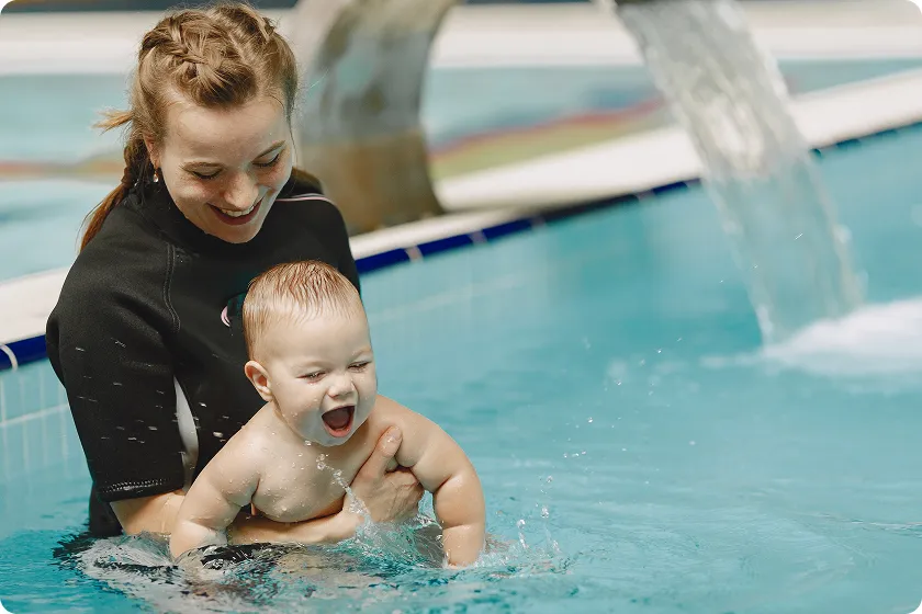 Calm baby resting after swimming private lessons designed for infants.